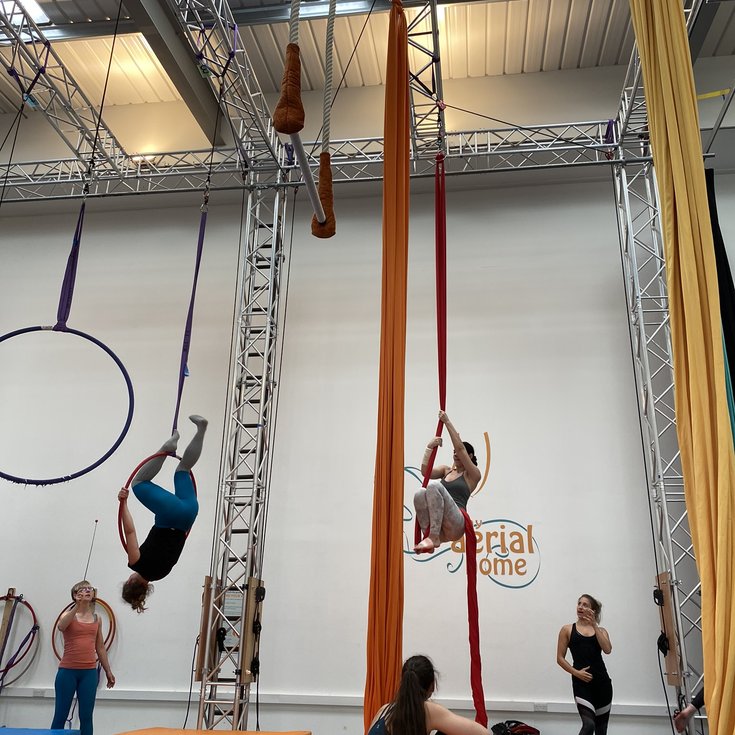 Adults on aerial hoops and silks at My Aerial Home